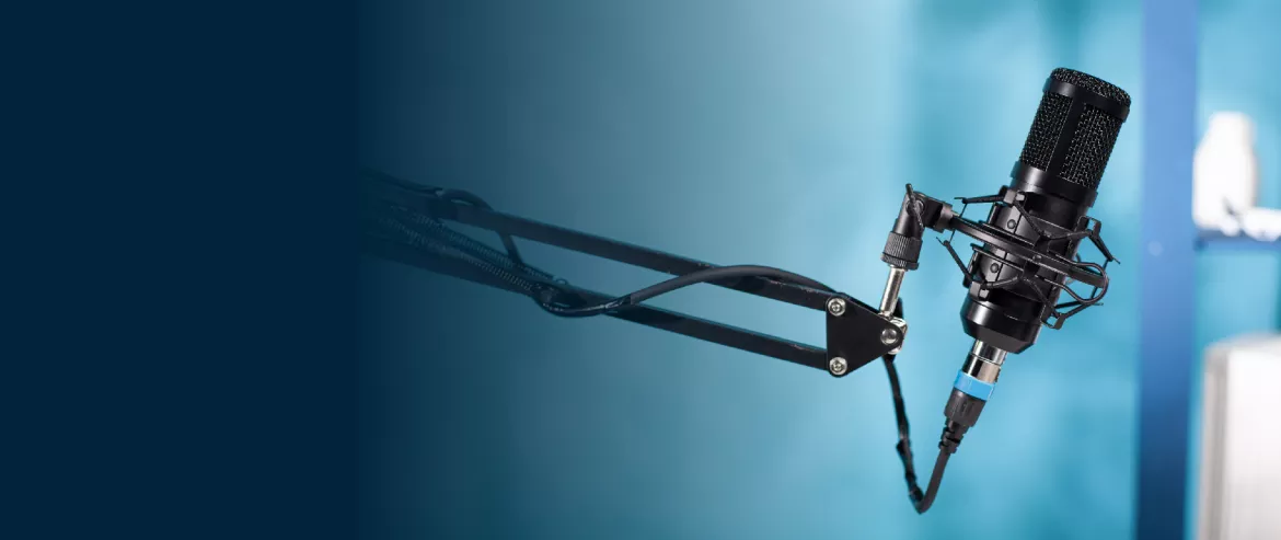 Podcast microphone in a recording studio with blue background in the image